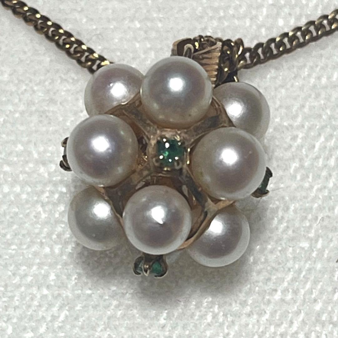 Akoya pearl necklace top with 12 round pearls and emerald-like green stones set in 14K gold weighing 3.7 grams