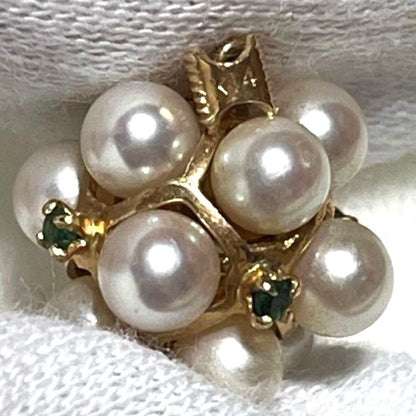 Akoya pearl necklace top with 12 round pearls and emerald-like green stones set in 14K gold weighing 3.7 grams