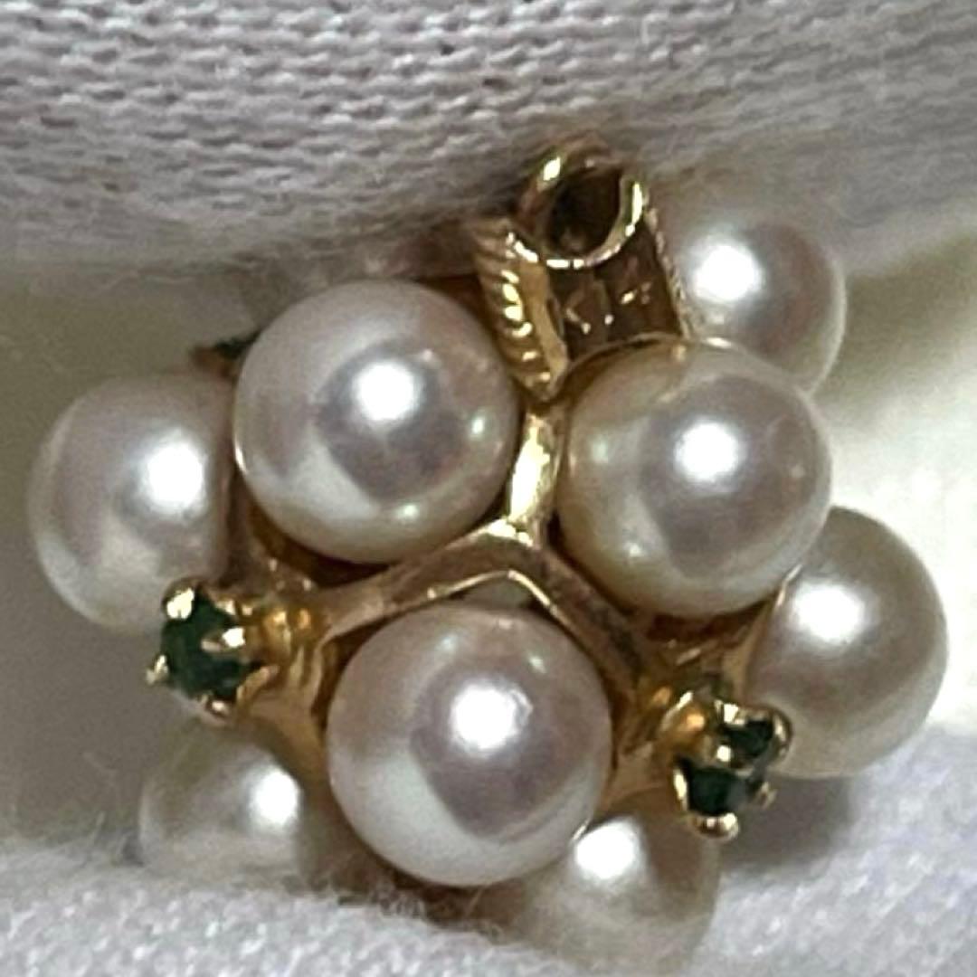 Akoya pearl necklace top with 12 round pearls and emerald-like green stones set in 14K gold weighing 3.7 grams