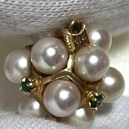 Akoya pearl necklace top with 12 round pearls and emerald-like green stones set in 14K gold weighing 3.7 grams