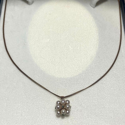 Akoya pearl necklace top with 12 round pearls and emerald-like green stones set in 14K gold weighing 3.7 grams