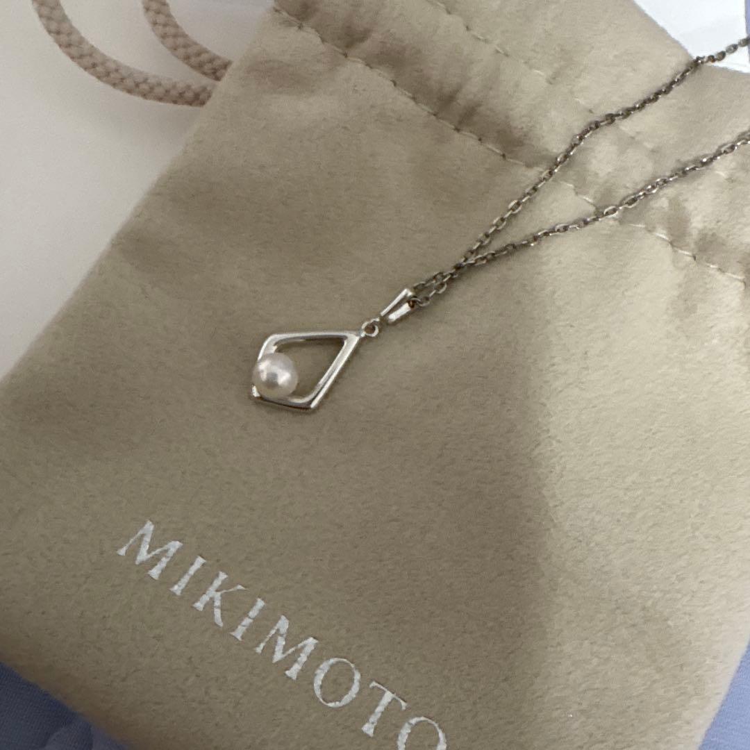 Mikimoto Pearl Necklace with silver chain and pearl pendant displayed with box and dedicated bag