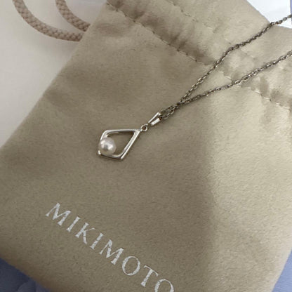 Mikimoto Pearl Necklace with silver chain and pearl pendant displayed with box and dedicated bag