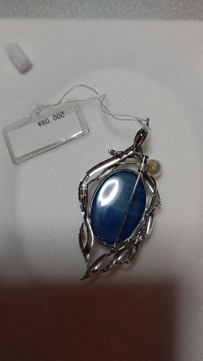 Brooch and pendant set with 7.5mm Akoya pearl, blue calcite, silver frame on white background