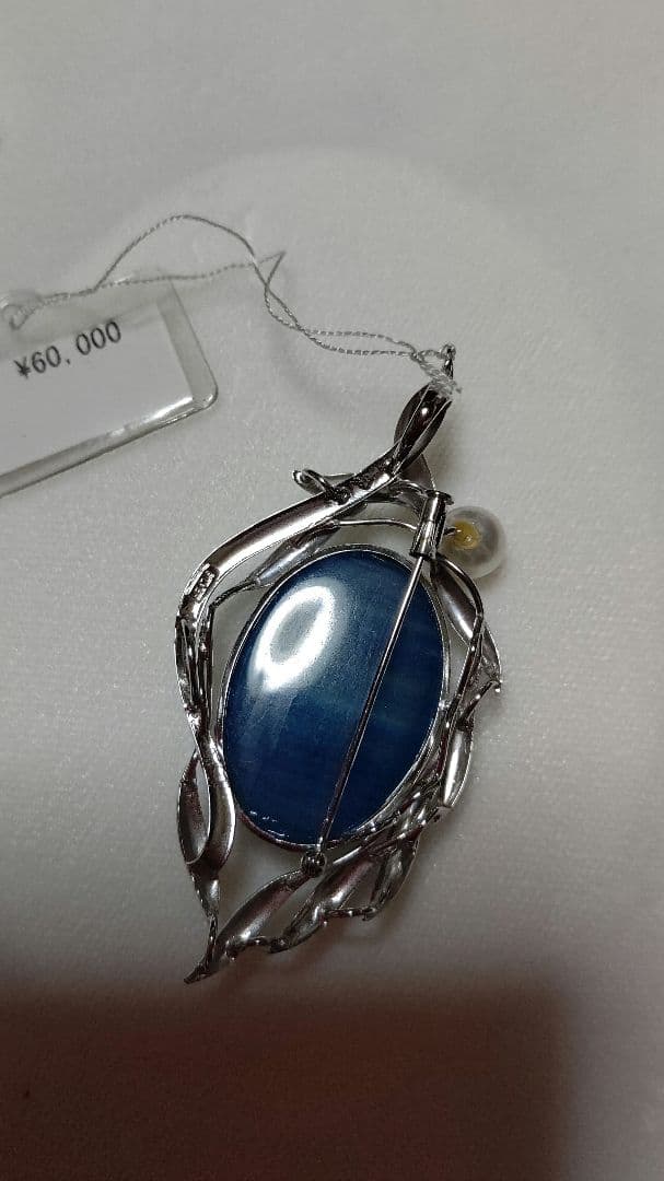 Brooch and pendant set with 7.5mm Akoya pearl, blue calcite, silver frame on white background
