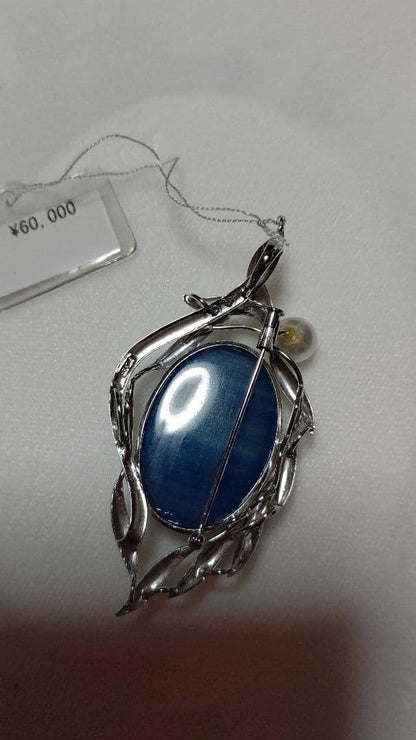 Brooch and pendant set with 7.5mm Akoya pearl, blue calcite, silver frame on white background