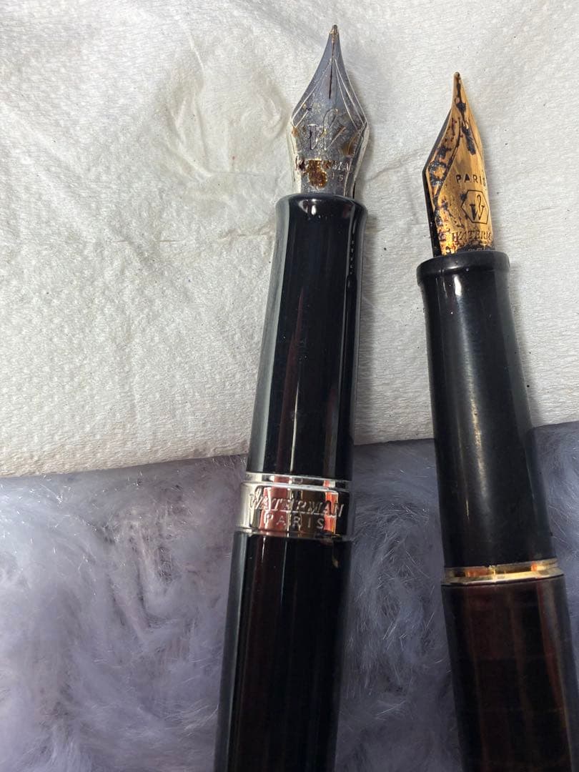 Set of 2 used Waterman fountain pens with gold accents shown side by side