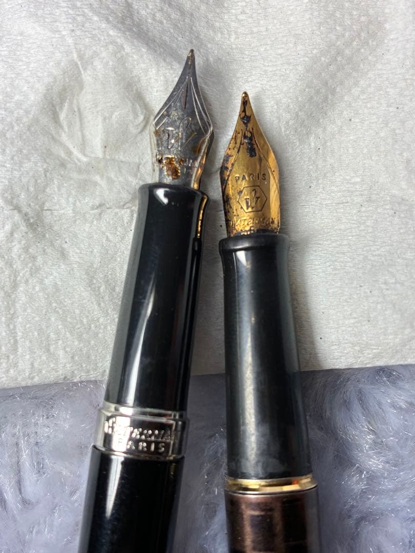 Set of 2 used Waterman fountain pens with gold accents shown side by side