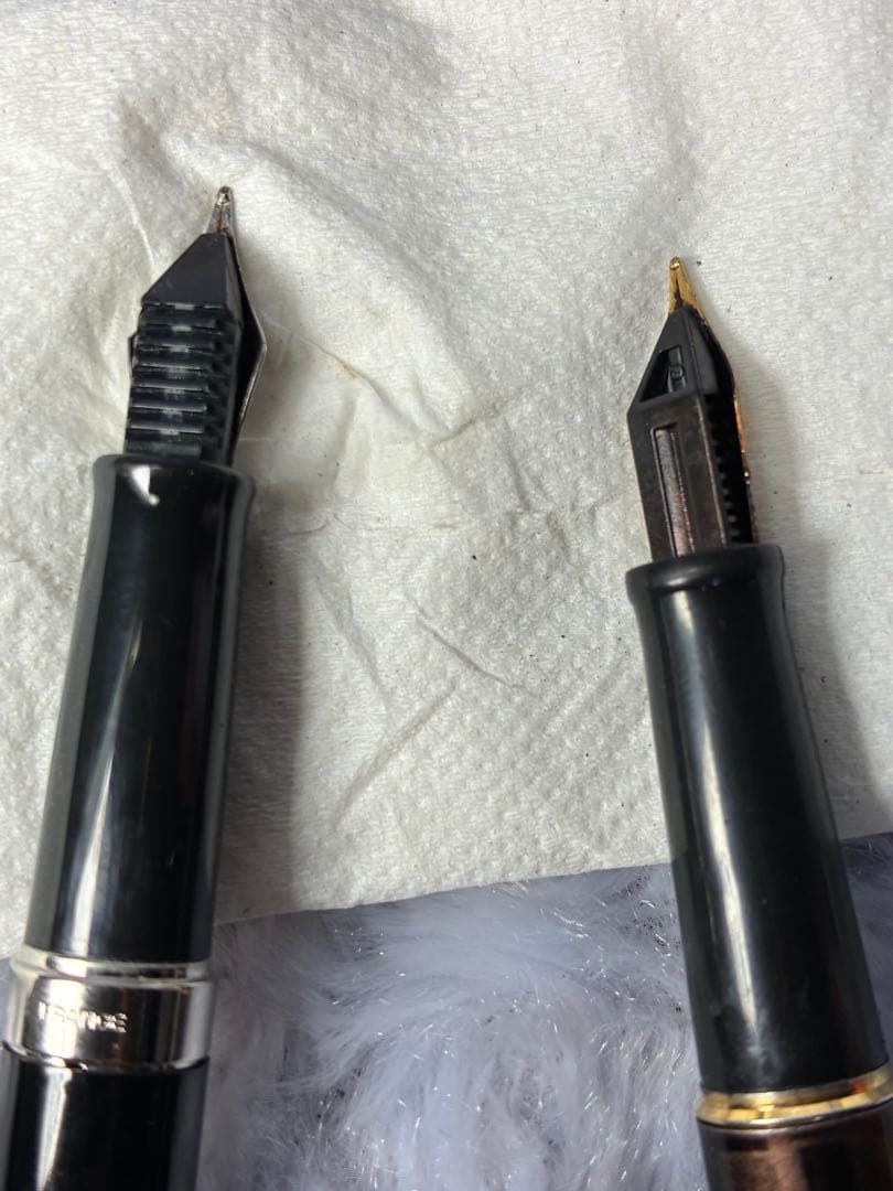 Set of 2 used Waterman fountain pens with gold accents shown side by side