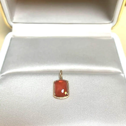 Agete Carnelian Charm made of 10 karat gold with an orange carnelian stone, no visible damage or discoloration