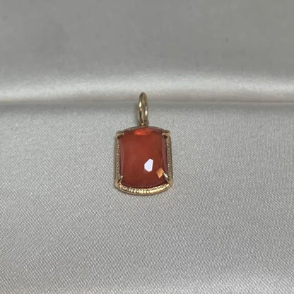 Agete Carnelian Charm made of 10 karat gold with an orange carnelian stone, no visible damage or discoloration