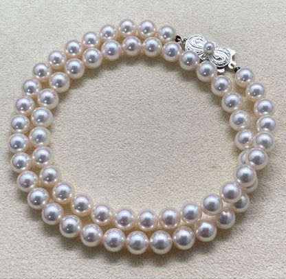 Mikimoto pearl necklace with approximately 7mm pearls and a silver clasp on a white background