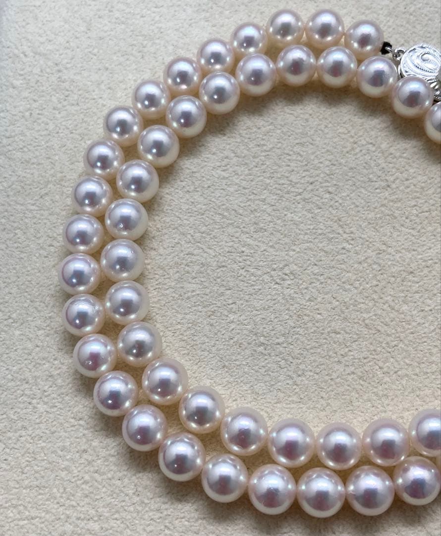 Mikimoto pearl necklace with approximately 7mm pearls and a silver clasp on a white background