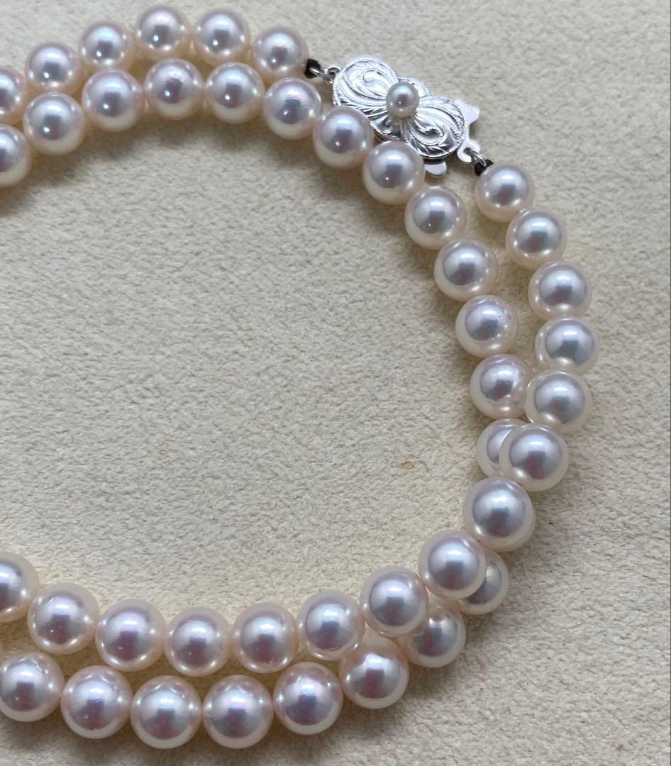Mikimoto pearl necklace with approximately 7mm pearls and a silver clasp on a white background