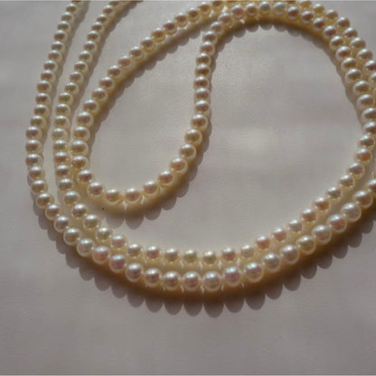New Akoya pearls genuine baby long necklace 80.5cm with 5.0-4.0mm white pink pearls and silver fittings on display