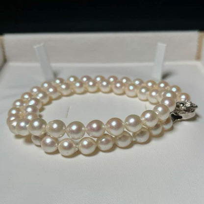 Akoya pearl semi-round necklace measuring 6.9 to 7.3mm with a 43 cm length displayed on a white background