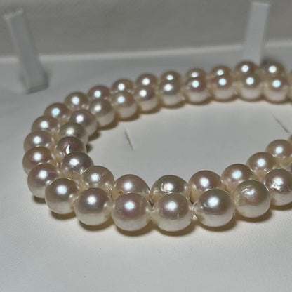 Akoya pearl semi-round necklace measuring 6.9 to 7.3mm with a 43 cm length displayed on a white background