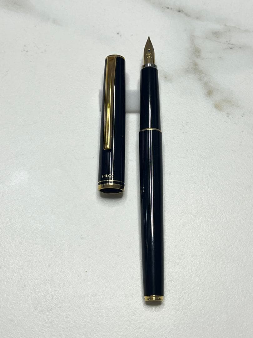 Pilot Japanese-made fountain pen with black and gold barrel and fine gold-plated nib