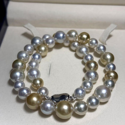 White butterfly pearl multi-color necklace with pearls sized 9.3-13.5 mm and silver clasp on display