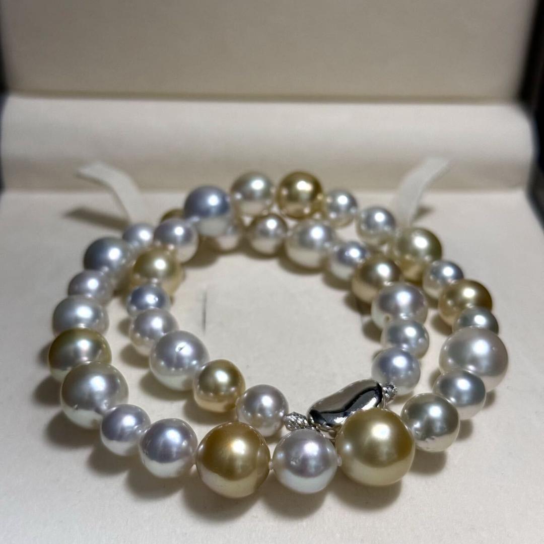 White butterfly pearl multi-color necklace with pearls sized 9.3-13.5 mm and silver clasp on display
