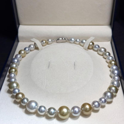 White butterfly pearl multi-color necklace with pearls sized 9.3-13.5 mm and silver clasp on display