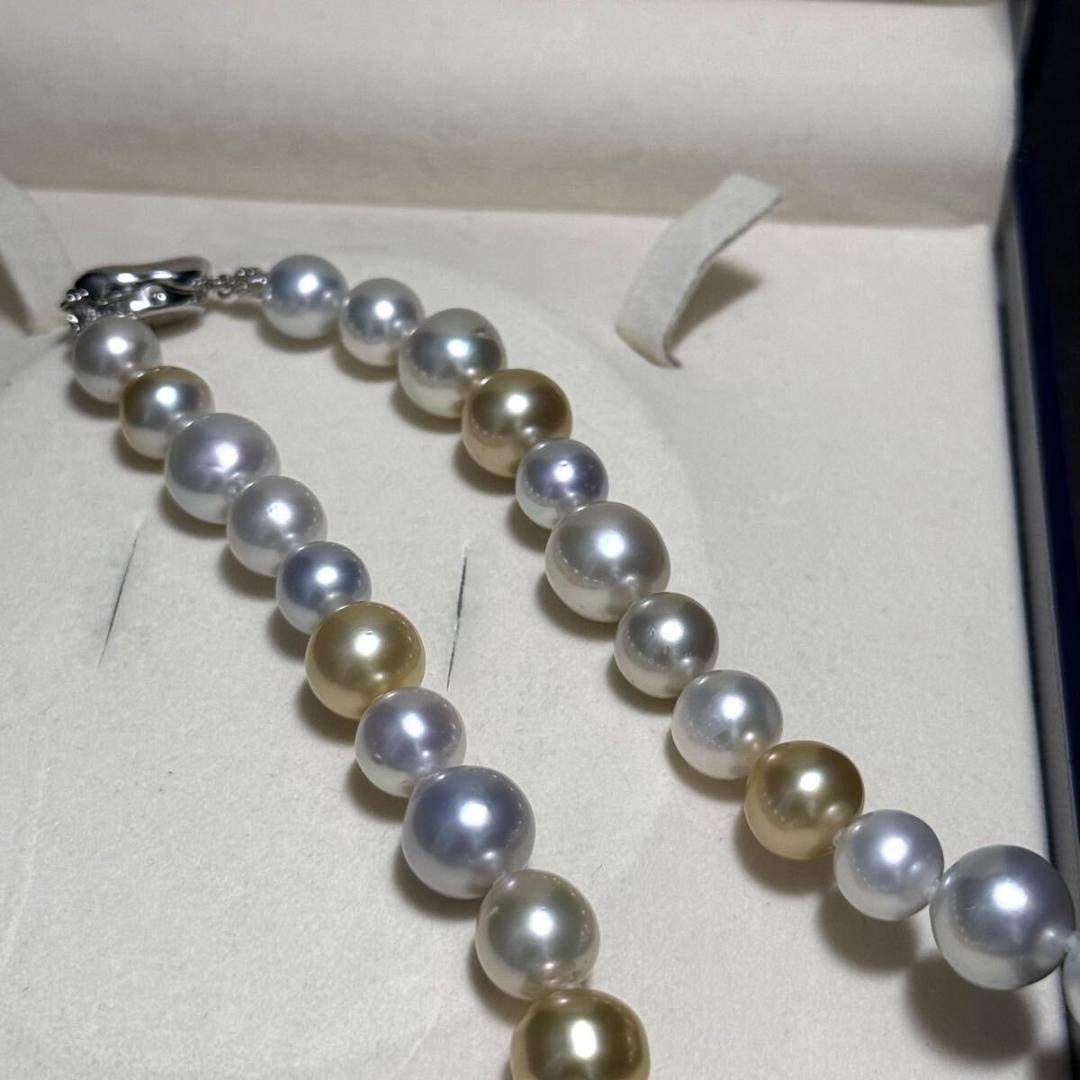 White butterfly pearl multi-color necklace with pearls sized 9.3-13.5 mm and silver clasp on display