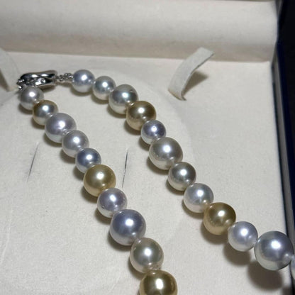 White butterfly pearl multi-color necklace with pearls sized 9.3-13.5 mm and silver clasp on display