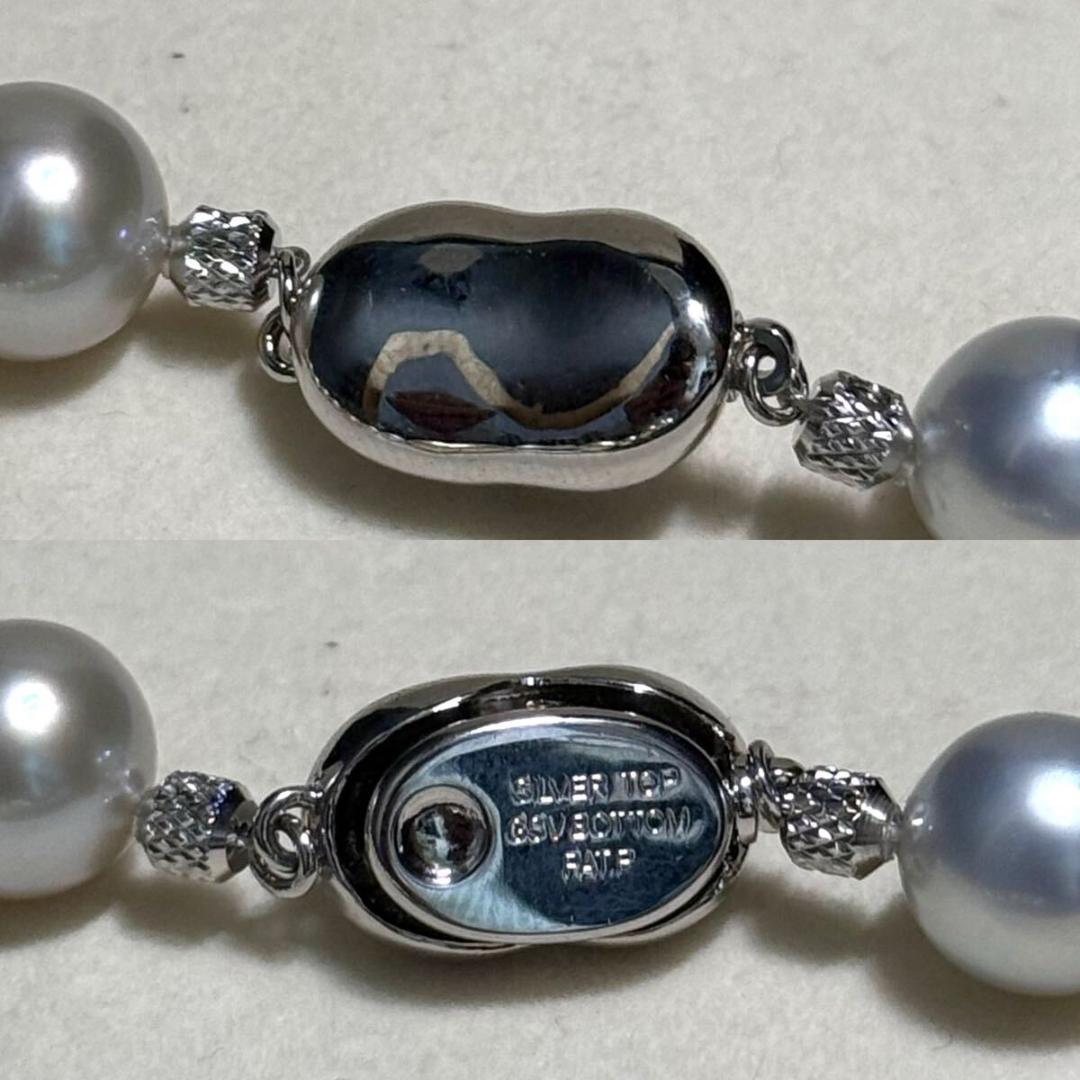 White butterfly pearl multi-color necklace with pearls sized 9.3-13.5 mm and silver clasp on display