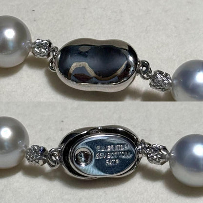 White butterfly pearl multi-color necklace with pearls sized 9.3-13.5 mm and silver clasp on display