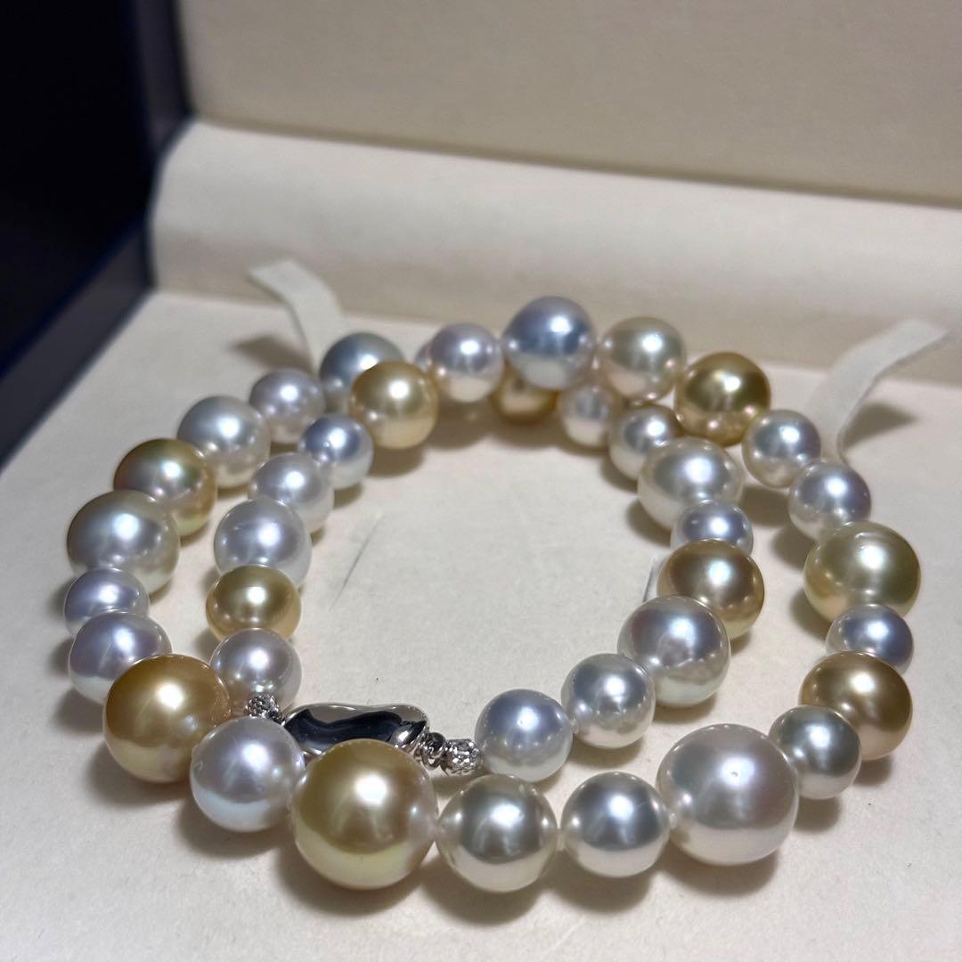 White butterfly pearl multi-color necklace with pearls sized 9.3-13.5 mm and silver clasp on display