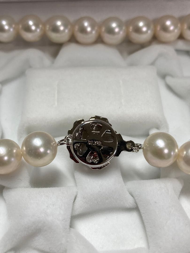 Akoya pearl necklace with pinkish white 9-9.5mm pearls and silver fittings displayed on white background