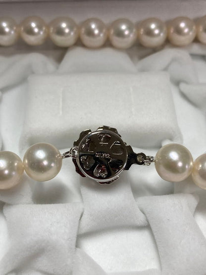 Akoya pearl necklace with pinkish white 9-9.5mm pearls and silver fittings displayed on white background