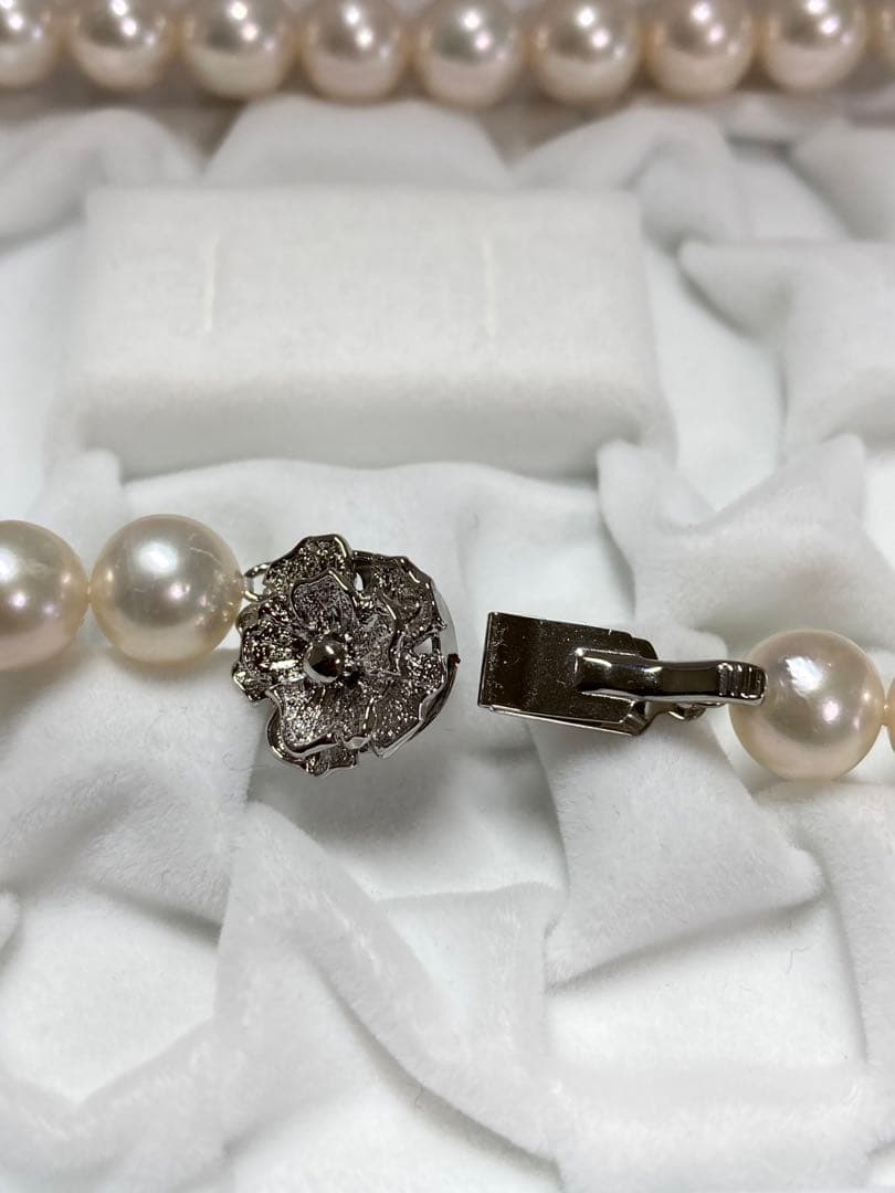 Akoya pearl necklace with pinkish white 9-9.5mm pearls and silver fittings displayed on white background