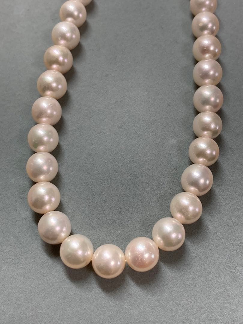 Akoya pearl necklace with pinkish white 9-9.5mm pearls and silver fittings displayed on white background