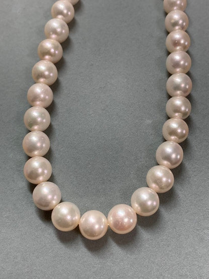 Akoya pearl necklace with pinkish white 9-9.5mm pearls and silver fittings displayed on white background