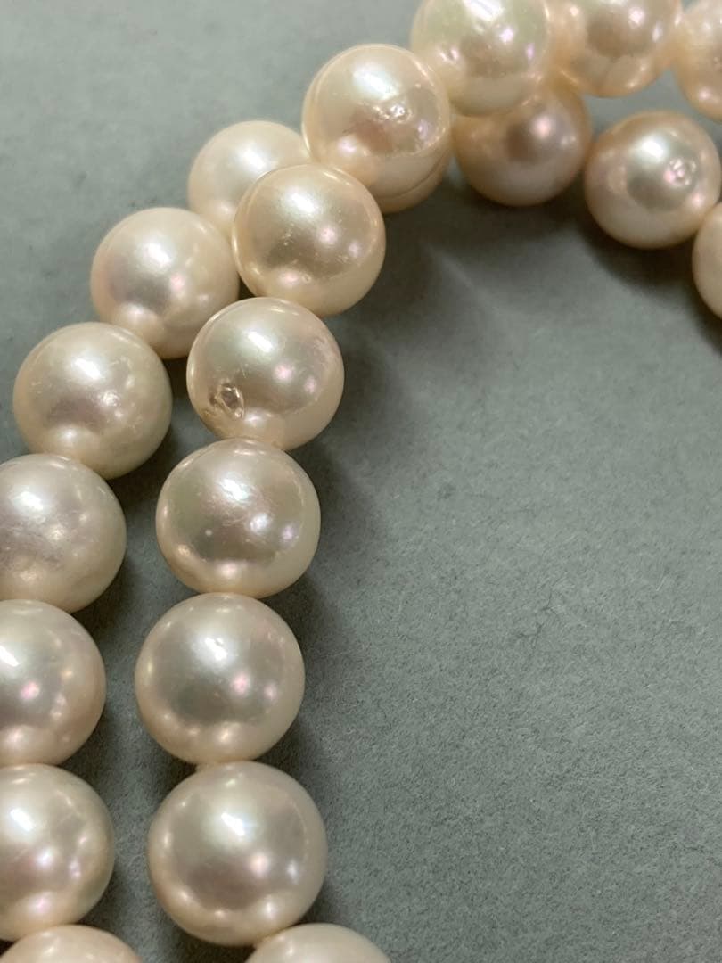 Akoya pearl necklace with pinkish white 9-9.5mm pearls and silver fittings displayed on white background