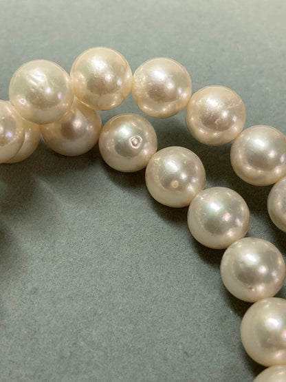 Akoya pearl necklace with pinkish white 9-9.5mm pearls and silver fittings displayed on white background