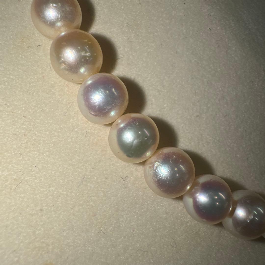 Tasaki pearl necklace with ribbon clasp measuring 43.5 centimeters displayed on white background