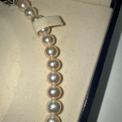 Tasaki pearl necklace with ribbon clasp measuring 43.5 centimeters displayed on white background