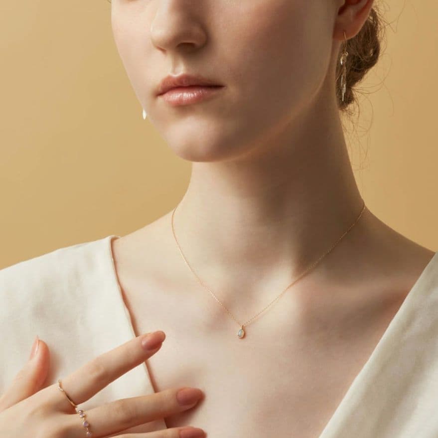 Opal droplet necklace with K10 gold and agate pendant on a delicate gold chain