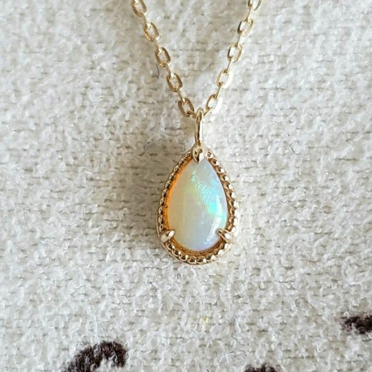 Opal droplet necklace with K10 gold and agate pendant on a delicate gold chain