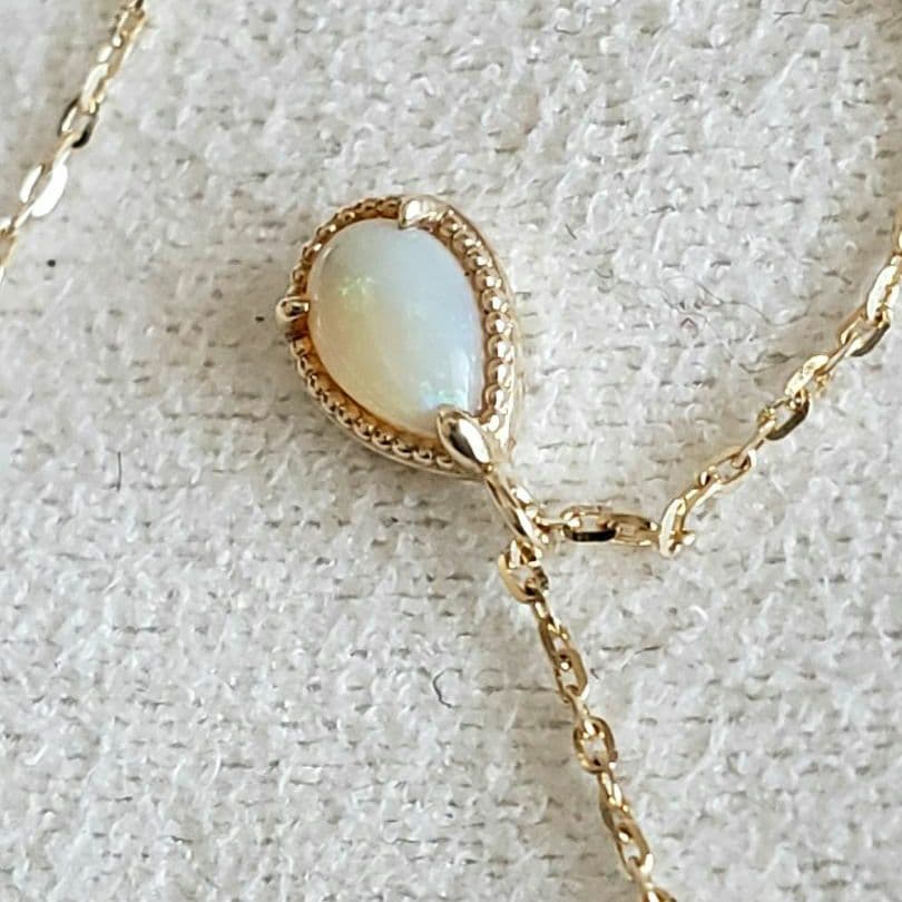 Opal droplet necklace with K10 gold and agate pendant on a delicate gold chain
