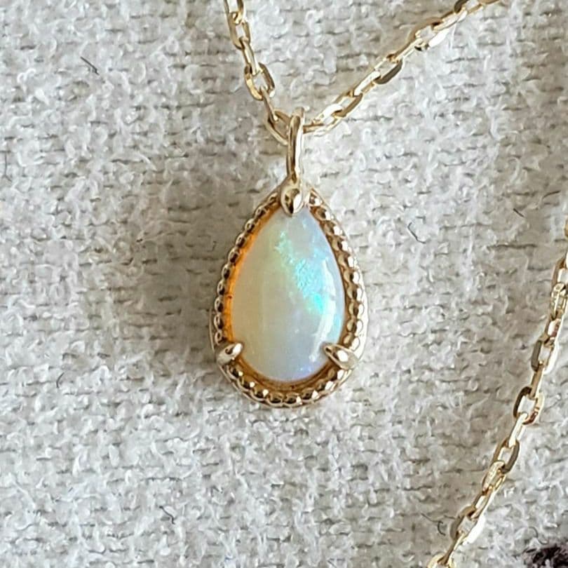 Opal droplet necklace with K10 gold and agate pendant on a delicate gold chain