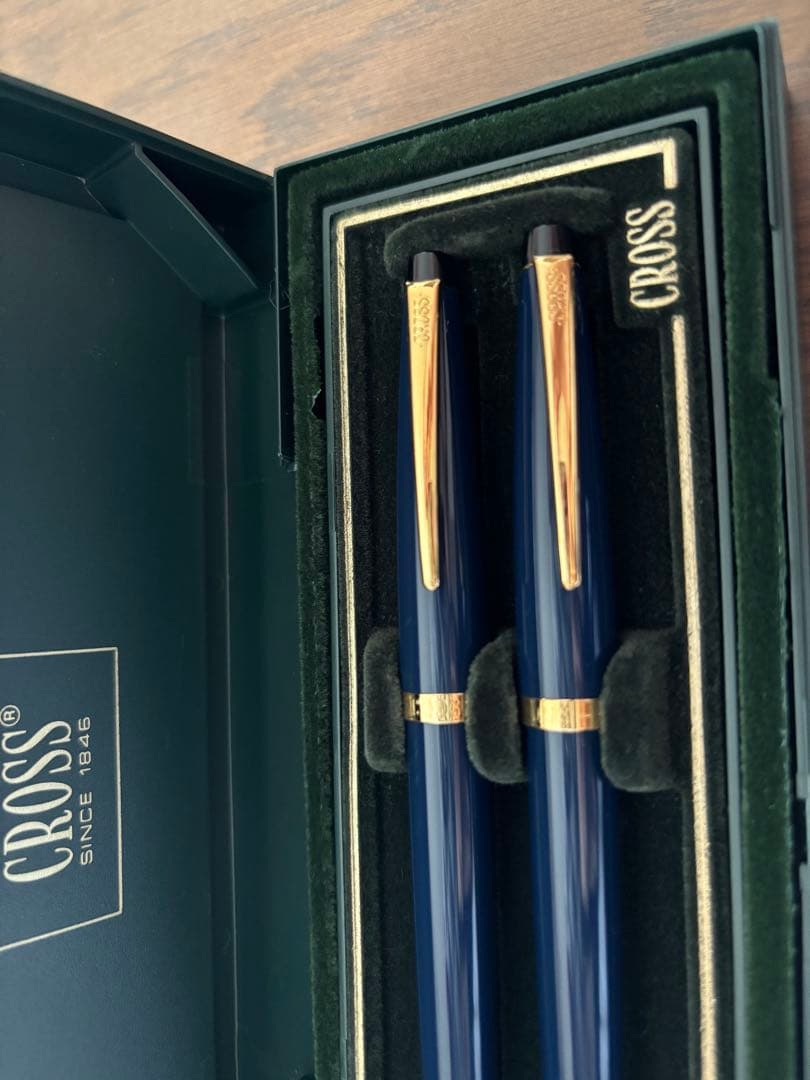 CROSS ballpoint pen and mechanical pencil set in navy and gold with a dedicated case showing slight cushion damage