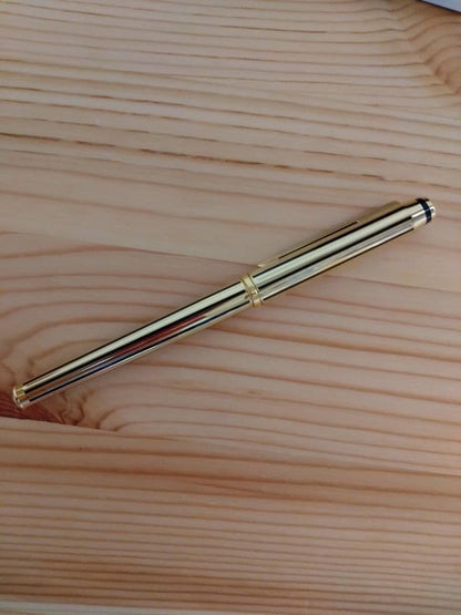 Used CROSS Selectip rolling ball pen in 22K gold with black lacquer finish and visible dent on pen body