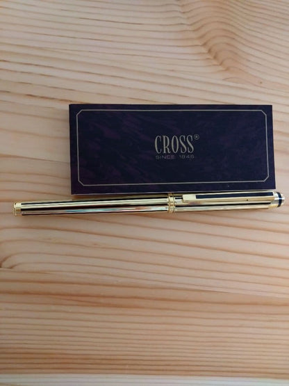 Used CROSS Selectip rolling ball pen in 22K gold with black lacquer finish and visible dent on pen body