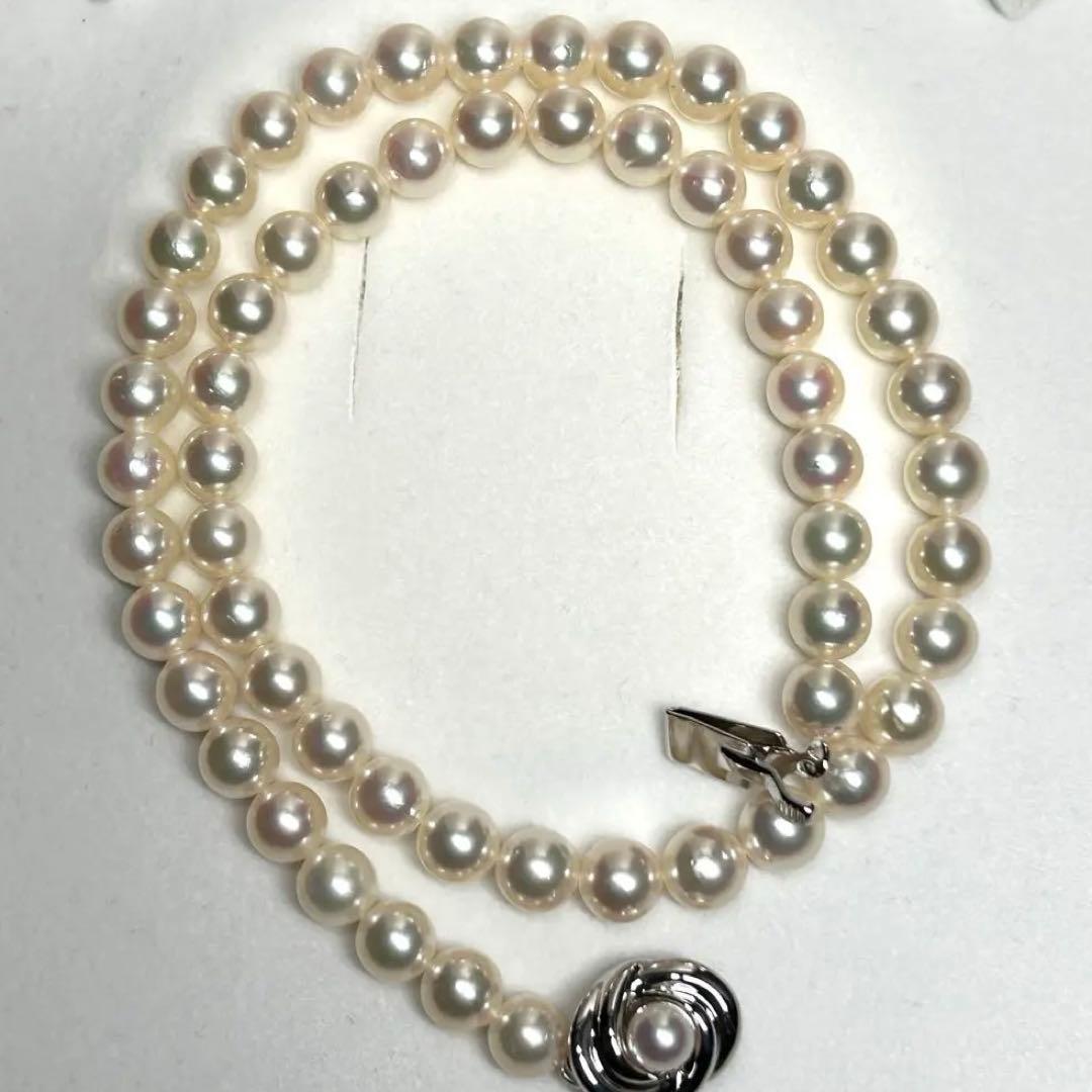 Tasaki Akoya pearl necklace with 7.5mm pearls and silver metal fittings laid flat