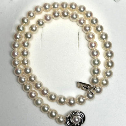 Tasaki Akoya pearl necklace with 7.5mm pearls and silver metal fittings laid flat