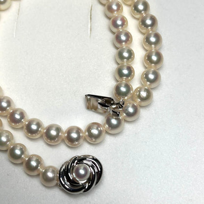 Tasaki Akoya pearl necklace with 7.5mm pearls and silver metal fittings laid flat
