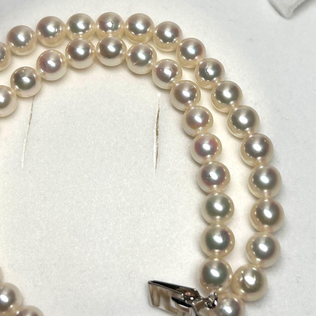 Tasaki Akoya pearl necklace with 7.5mm pearls and silver metal fittings laid flat